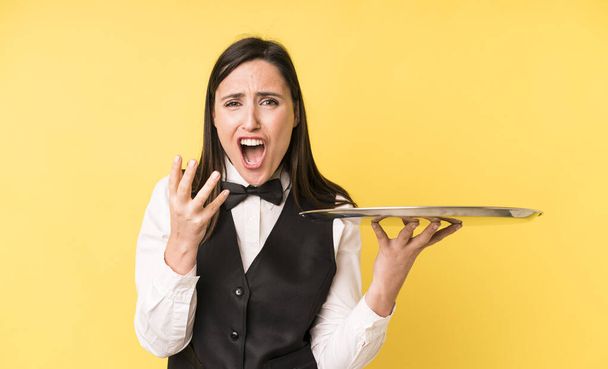 young adult pretty woman looking desperate, frustrated and stressed. waiter and tray concept - Fotoğraf, Görsel