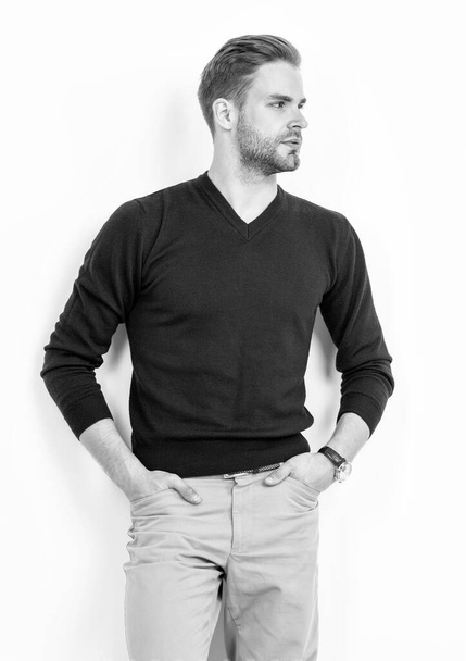 Attractive guy with serious look pose keeping hands in pants pockets in casual fashion style, model - 写真・画像