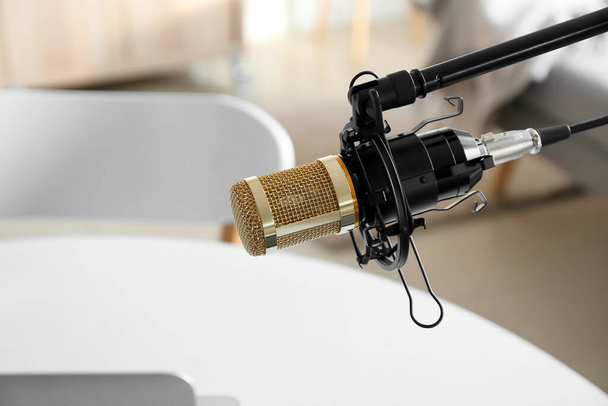 Modern microphone in light room, closeup - 写真・画像
