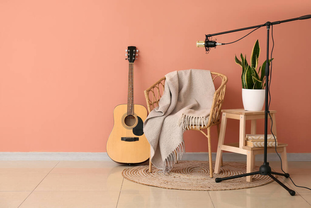 Stand with professional microphone, guitar, chair and stepladder stool  in room interior - Фото, зображення