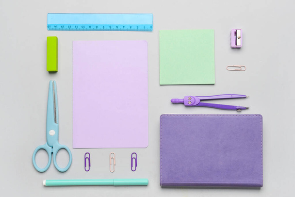 Different stationery supplies on grey background - 写真・画像