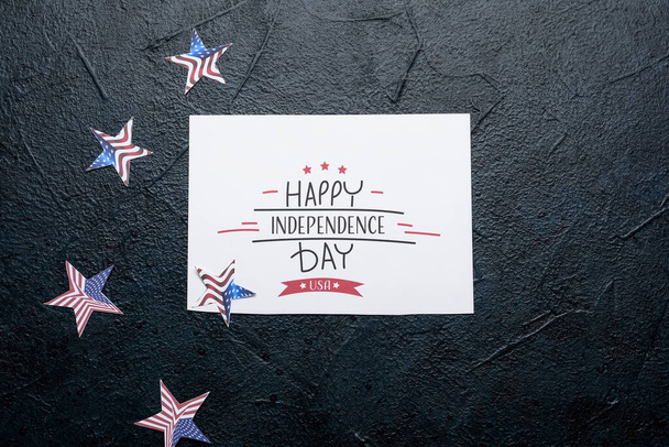 Greeting card with text HAPPY INDEPENDENCE DAY USA and stars on dark background - Photo, Image