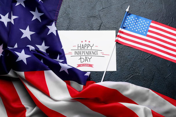 Greeting card with text HAPPY INDEPENDENCE DAY and USA flags on dark background - Fotoğraf, Görsel
