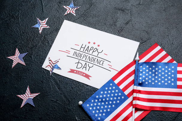 Greeting card with text HAPPY INDEPENDENCE DAY, stars and USA flags on dark background - Fotoğraf, Görsel