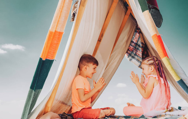 Happy children. Brother and sister relationships. Affection and care. Children family playing in tent. Cute kids having fun outdoors. - Photo, Image