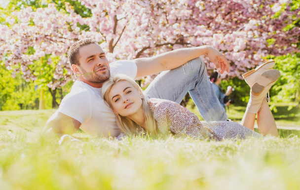 Happy embracing couple. Beautiful young family enjoying flowering garden. Romantic and love, sensual touch. Girlfriend and boyfriend. Valentine. - Φωτογραφία, εικόνα