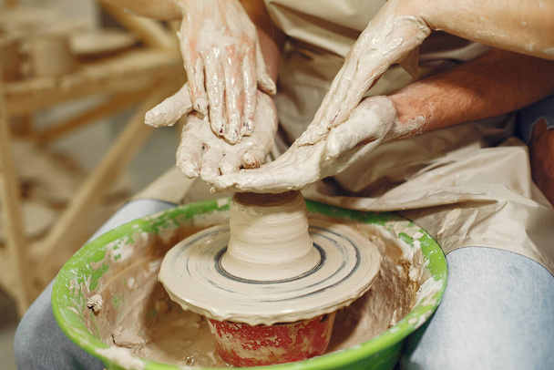 Close up photo of hands making on a pottery - Zdjęcie, obraz