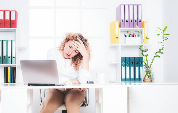 Sad office woman. Portrait of businesswoman suffering from headache in office. Disappointed young businesswoman. Trouble of business. Stressed business woman. - 写真・画像