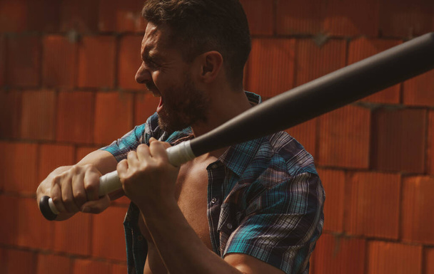 Portrait of handsome man with baseball bat for fighting. Dangerous man with serious emotion. - Φωτογραφία, εικόνα