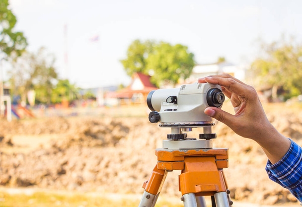 civil engineer land survey with theodolite outdoor at construction site. surveyor builder and engineer working with theodolite. - Фото, изображение