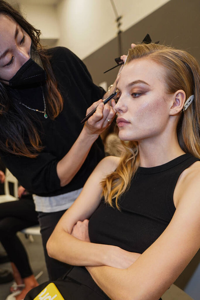 MILAN, ITALY - FEBRUARY 25: A model getting ready backstage before the Elisabetta Franchi fashion show during the Milan Fashion Week Fall/Winter 2022/2023 on February 25, 2022 in Milan, Italy. - Фото, изображение