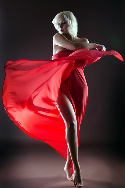 Graceful blonde dancing naked with red cloth - Foto, imagen
