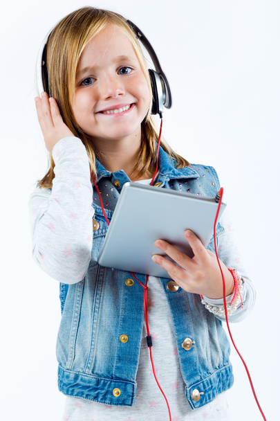 Beautiful child listening to music with digital tablet. - Zdjęcie, obraz