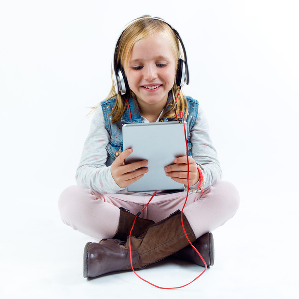 Beautiful child listening to music with digital tablet. - Zdjęcie, obraz