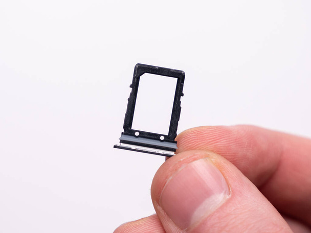SIM tray for SIM card in smartphone close-up view on a white background - Foto, imagen