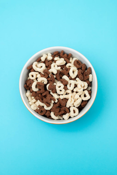 simple and chocolate cereals letters in orange bowl - 写真・画像