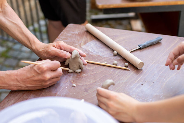 close up of hands making pottery clay - Fotó, kép