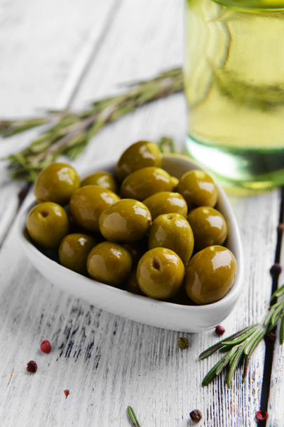Marinated olives on table - Фото, изображение