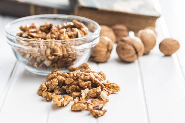 Peeled walnut kernels on a white table. - Фото, зображення