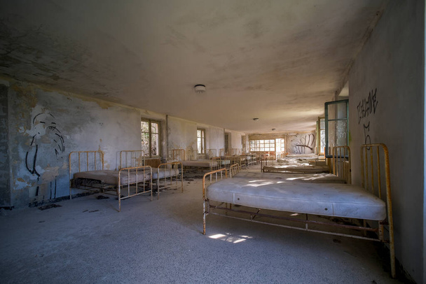 orphanage dormitory in large abandoned house. High quality photo - Foto, afbeelding