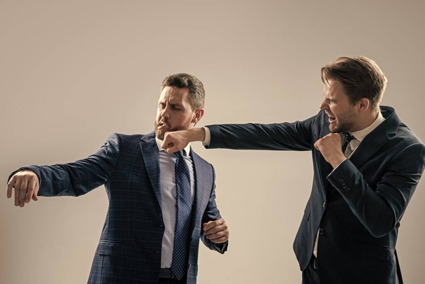 fist in face. colleagues have disagreement conflict. businessmen punching in fight. - Fotoğraf, Görsel