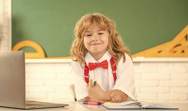 happy child boy in bow tie study in school classrrom at blackboard, back to school - Fotografie, Obrázek