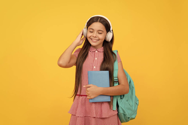 cheerful child with school bag. music. teen girl carry backpack. back to school. - Foto, afbeelding
