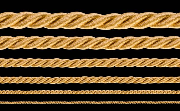 collection of various golden ropes string on black background - Fotó, kép
