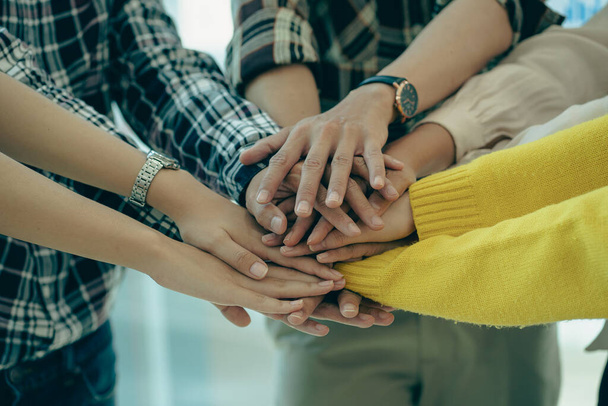 Young modern businesspeople shaking hands, feeling the power of working together. or celebrate the start of a new project in a modern office meeting. teamwork support concept - Foto, Imagem