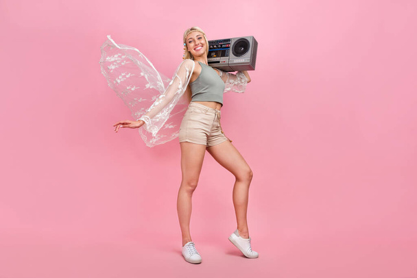Full body photo of millennial blond lady with boombox wear top cape shorts footwear isolated on pink background - Photo, image