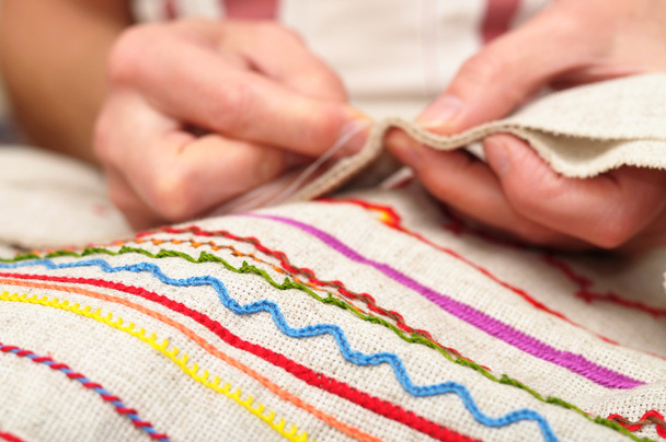 patterns on fabric and hands sewing - 写真・画像