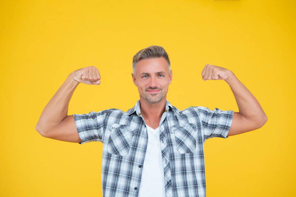 strong mature man with grizzle hair on yellow background - Fotografie, Obrázek