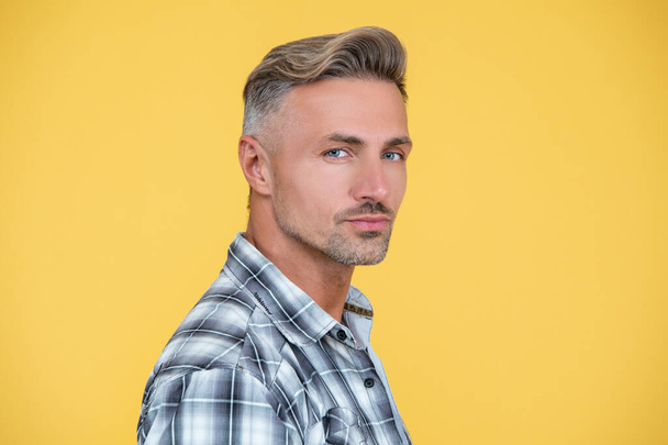 mature man with hoary hair on yellow background - Fotografie, Obrázek