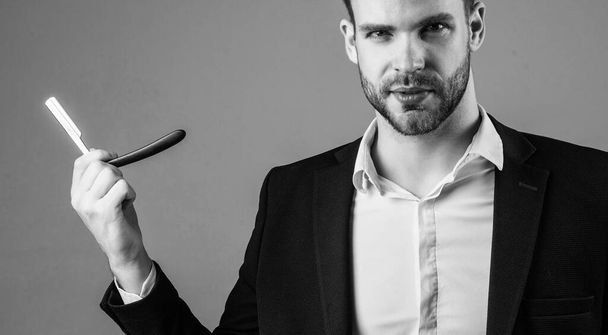 male with fashionable groomed hair and beard use razor blade, hairdresser - Photo, image
