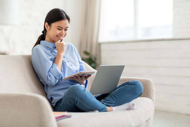 Excited asian woman attending online course from home - Foto, Bild