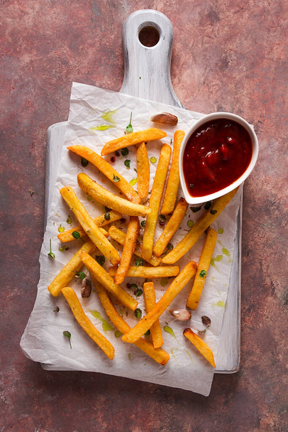 Fried French fries, in a paper bag, on an abstract background, no people, rustic, - Φωτογραφία, εικόνα