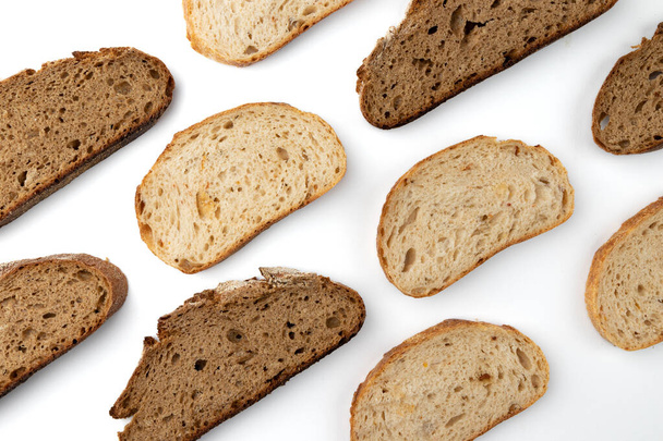 pattern with slices of wheat and rye bread isolated on white background, top view - Zdjęcie, obraz