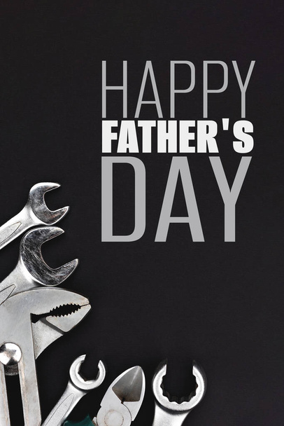 Work tools on black background. Happy fathers day concept - Foto, imagen