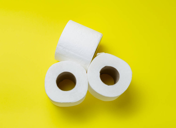 zjeżdżalnia rolki papieru toaletowego na żółtym tle. - Zdjęcie, obraz