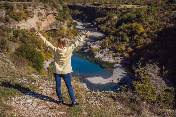 Montenegro. Woman tourist on the background of Clean clear turquoise water of river Moraca in green moraca canyon nature landscape. Travel around Montenegro concept - Foto, Imagem