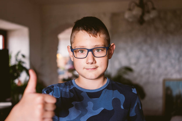 Portrait of caucasian boy wearing eyeglasses at home - Photo, image
