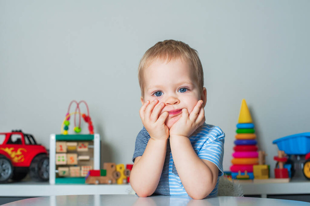 Portrait of toddler boy with facial expressions in interior of childrens room at home.. - Fotoğraf, Görsel