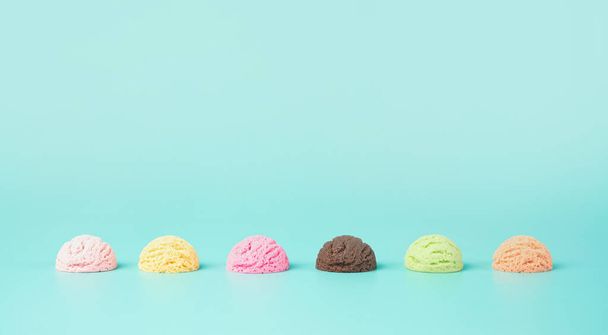 Assortment of various flavor ice cream balls on a light blue background. Summer, refreshment minimal concept. - Photo, Image