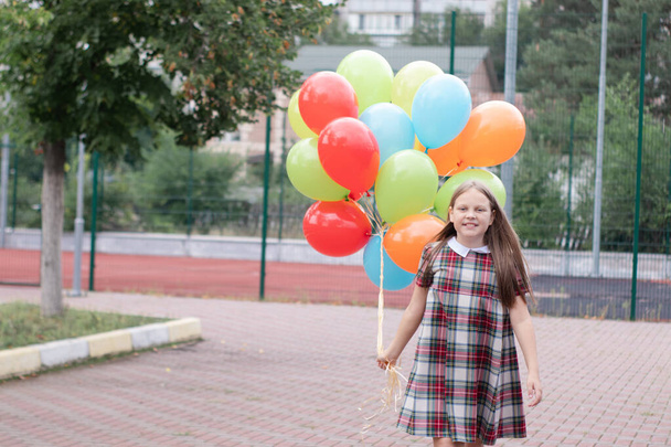 Teenage girl with colorful helium air balloons having fun outdoors. Tween Party. enjoying summer. - Photo, Image