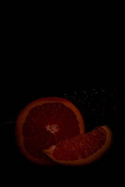 Orange fruit on the black background - Foto, imagen