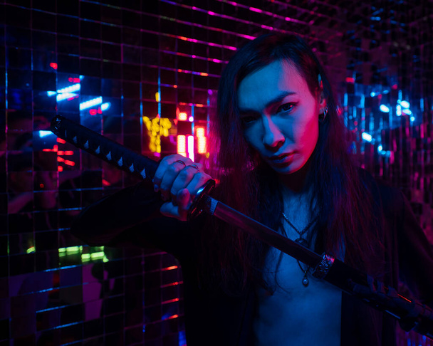 Male transgender neon light studio. Asian with samurai sword. - Fotó, kép