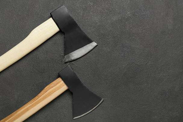 Axes with wooden handles on dark background - Photo, image