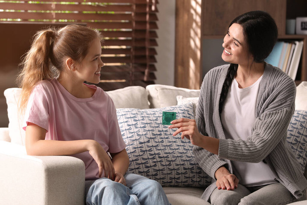 Mother talking with her teenage daughter about contraception at home. Sex education concept - Photo, Image