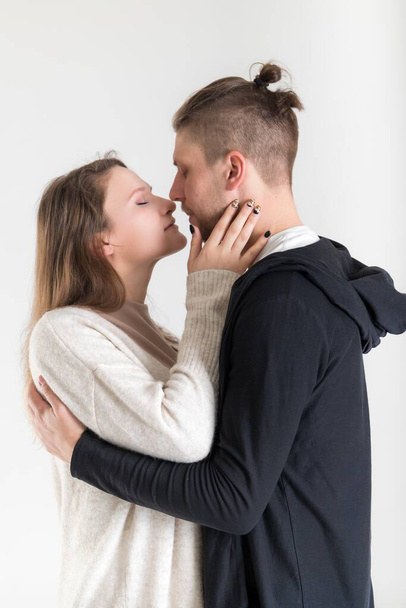 Young caucasian couple of lovers close-up vertical portrait on white background - Valokuva, kuva