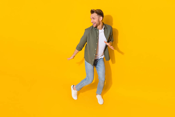 Full length body size view of attractive cheerful carefree guy dancing moving having fun isolated over bright yellow color background - Фото, зображення
